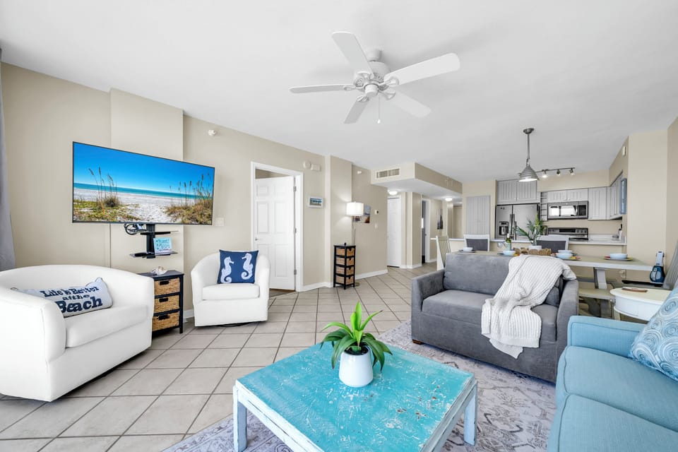 Where coastal blues meet plush seating and an open-plan kitchen flows seamlessly behind.