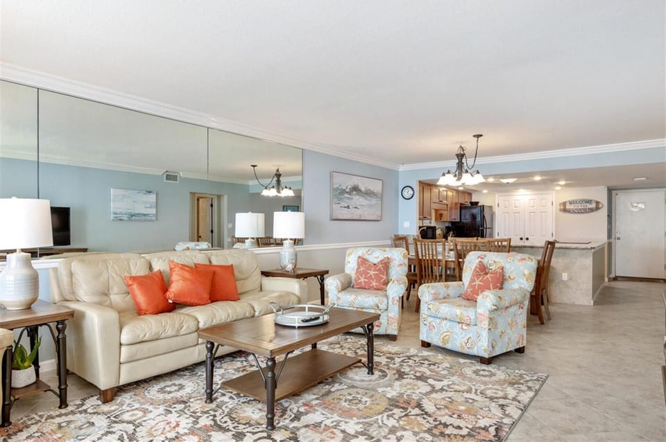 Relax in your spacious open-concept living area featuring plush seating and a fully equipped kitchen for memorable vacation moments.