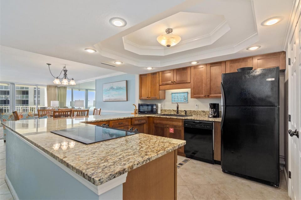 Your fully equipped kitchen features granite countertops and modern appliances, perfect for preparing meals while enjoying ocean views.