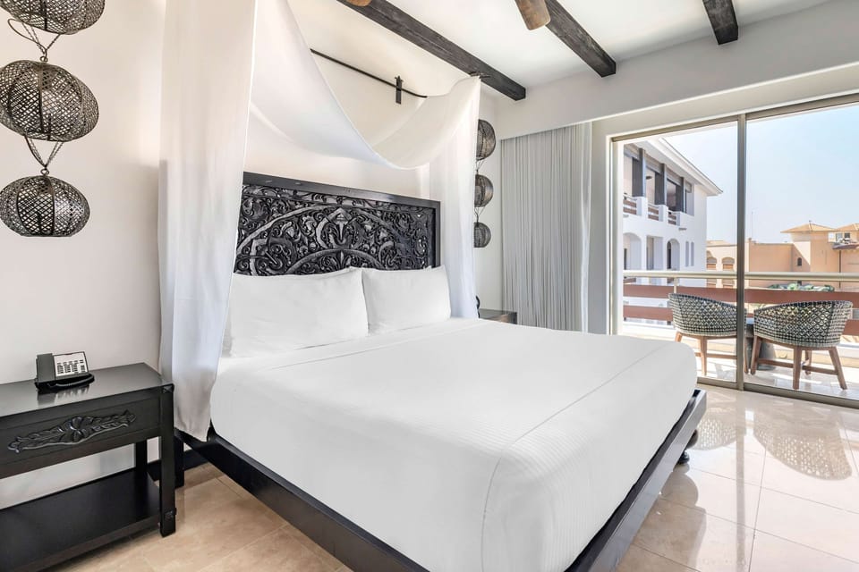 Sink into crisp linens in a calm, light-filled bedroom.