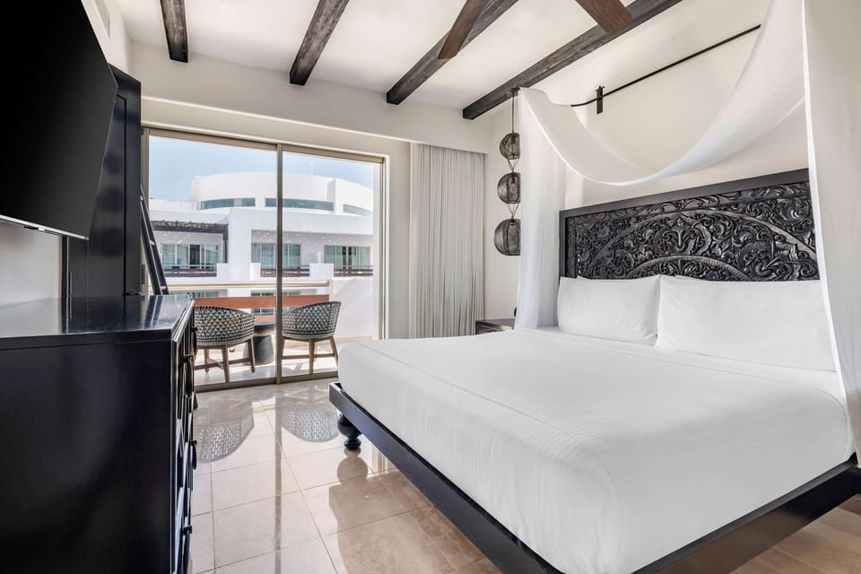 Recharge in a bright bedroom framed by balcony sunshine.