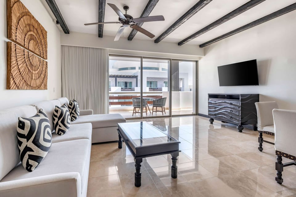 Unwind on the plush sectional with breezy balcony views.