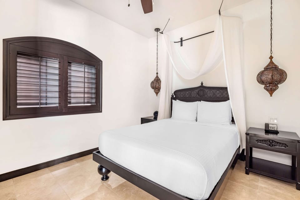Sink into crisp linens beneath an elegant canopy bed.
