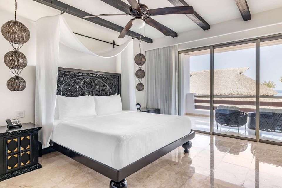 Relax in crisp linens as sunlight pours through the sliders.