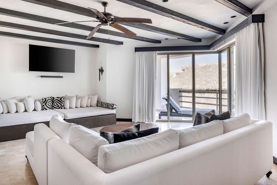Unwind together in a sunlit lounge with balcony breeze.