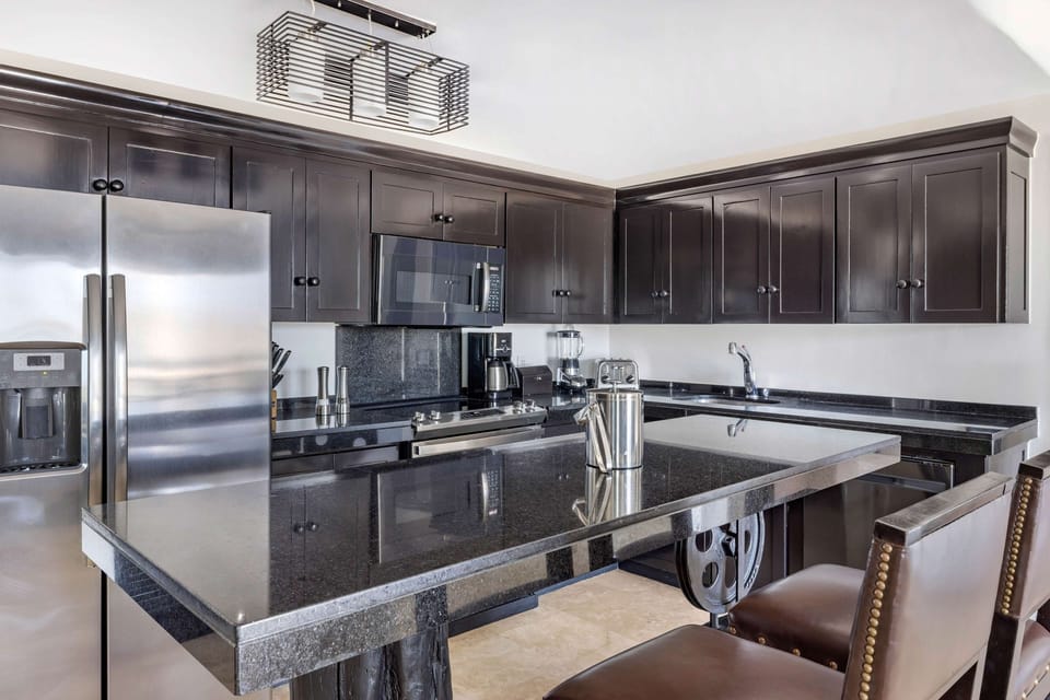 Cook effortlessly in a sleek kitchen with expansive granite counters.