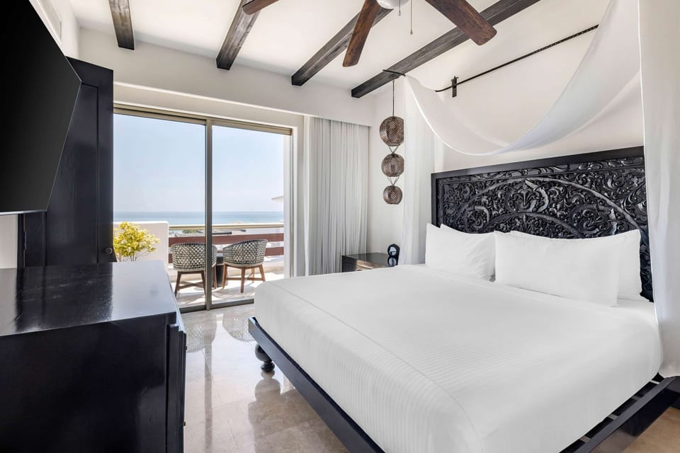 Wake to ocean horizons from your luxe canopy king bed.