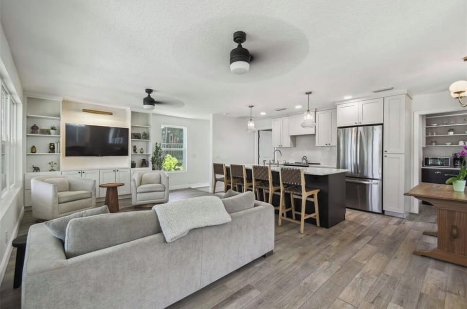 2nd floor open concept living room, kitchen and island with many seating options