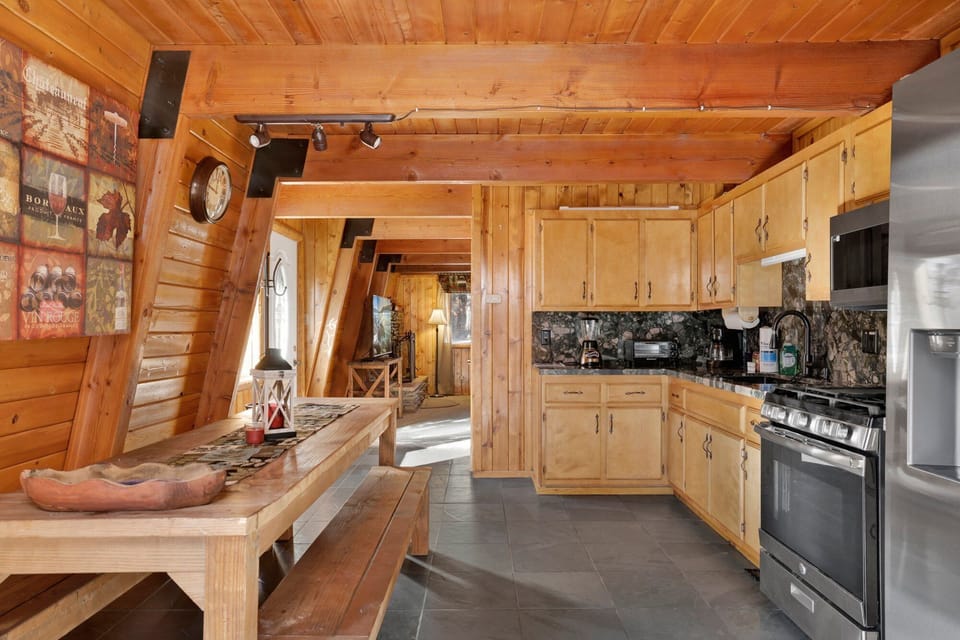 Fully equipped cabin kitchen with ample cabinetry, stove, fridge, microwave, and coffee maker—perfect for cooking meals, morning coffee, and feeling right at home on your stay.