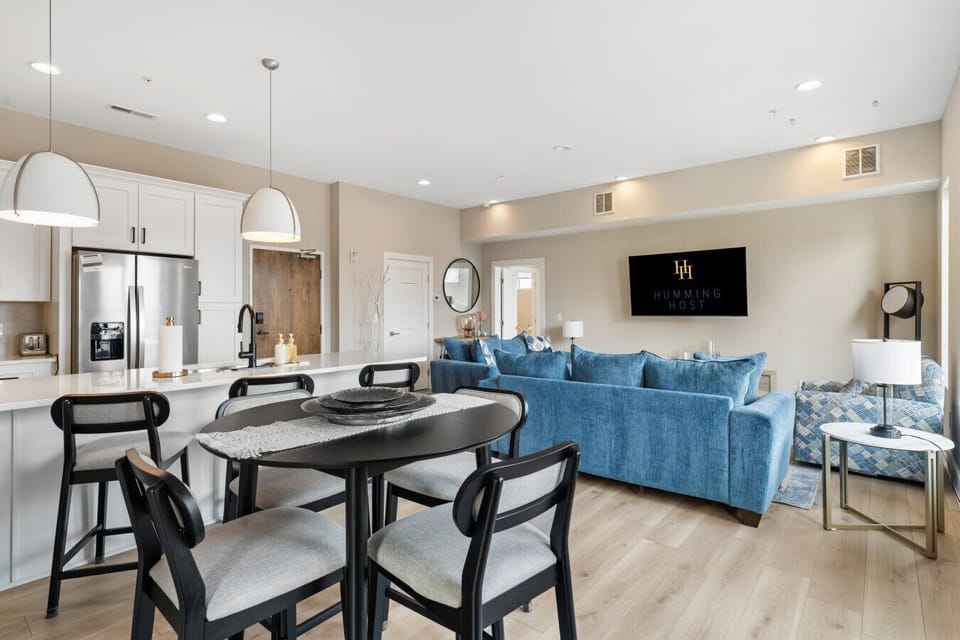 Open-concept living and dining area with modern kitchen, stylish furnishings, and a cozy lounge space.