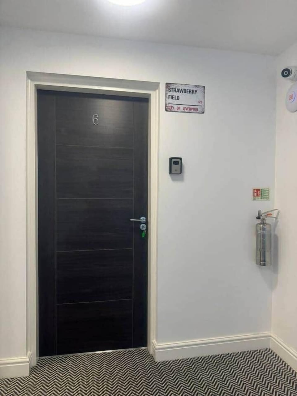 outside  apartment door. fire extinguisher for safety 