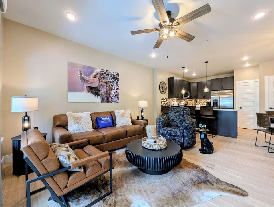 Unwind in this stylish open-concept living space with plush seating, modern kitchen, and thoughtful touches for your perfect getaway.