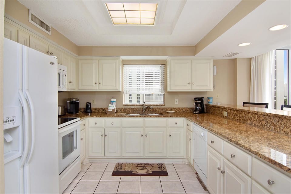 Your fully equipped kitchen offers everything you need to prepare meals, with granite countertops and modern appliances creating a welcoming cooking space.