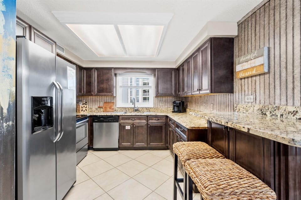 Your fully equipped kitchen features granite counters, stainless appliances, and warm wood cabinets for effortless meal preparation.