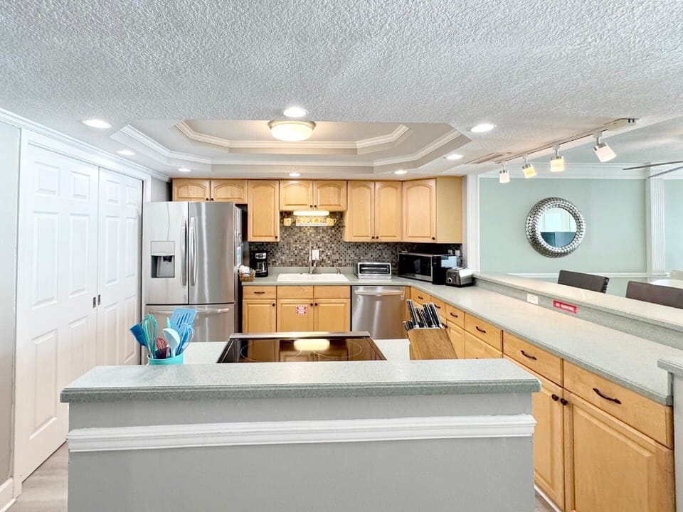 Your spacious kitchen features modern appliances, granite countertops, and an open island perfect for preparing meals and gathering together.