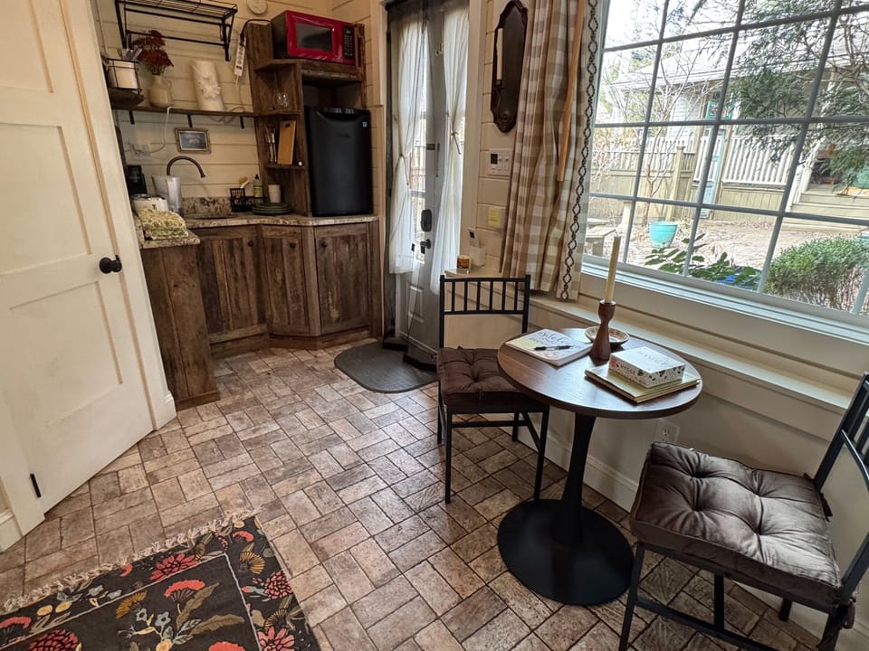 Charming tiny cottage with rustic textures, natural light, and a cozy dining nook perfect for slow mornings.