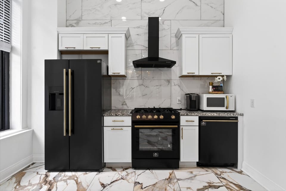 Here is a closer look at the chef-ready kitchen setup with plenty of counter space. The black and gold stove is ready for your culinary creations.