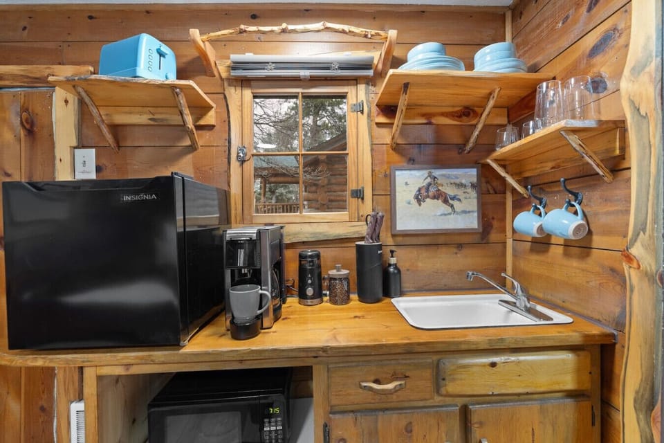 Start your mornings right at a fully equipped coffee station with mugs, glassware, and a convenient sink.