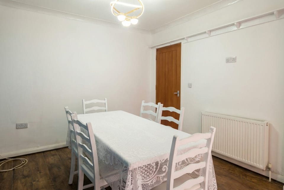 Gather around the white dining table for shared meals in the bright dining room.