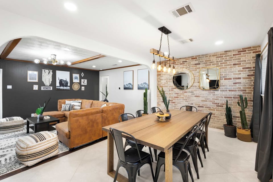 Gather 'round the table in this stylish space, where rustic brick walls, modern metal seating, and warm lighting create the perfect recipe for memorable group meals.