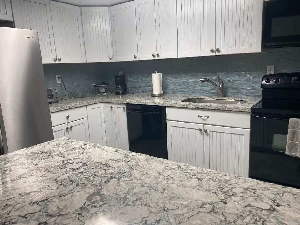 Newly renovated kitchen with modern appliances and granite countertops; ready for your culinary adventures.