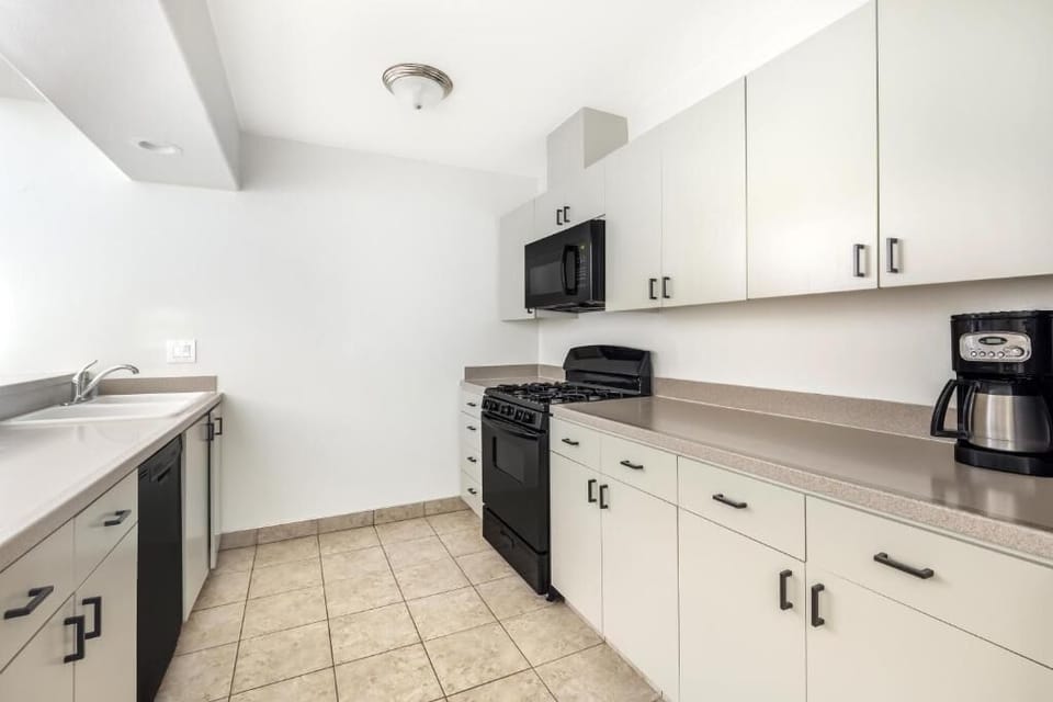 Cook comfortably with full-size stove, dishwasher, and generous counters.