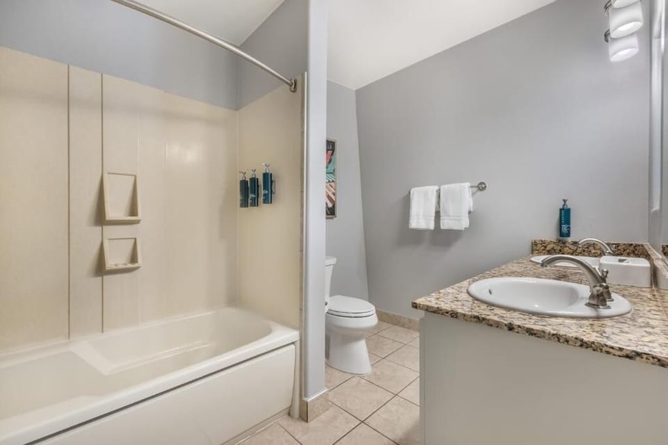 Rinse off and relax with a shower-tub combo and fresh towels.