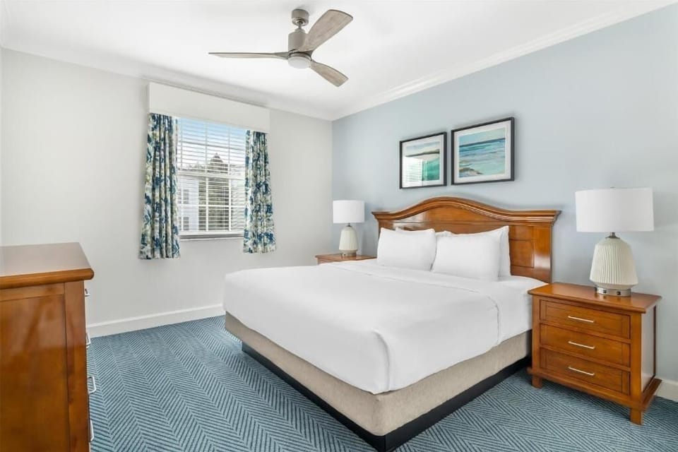 Drift off in serene king comfort under a cool ceiling fan.
