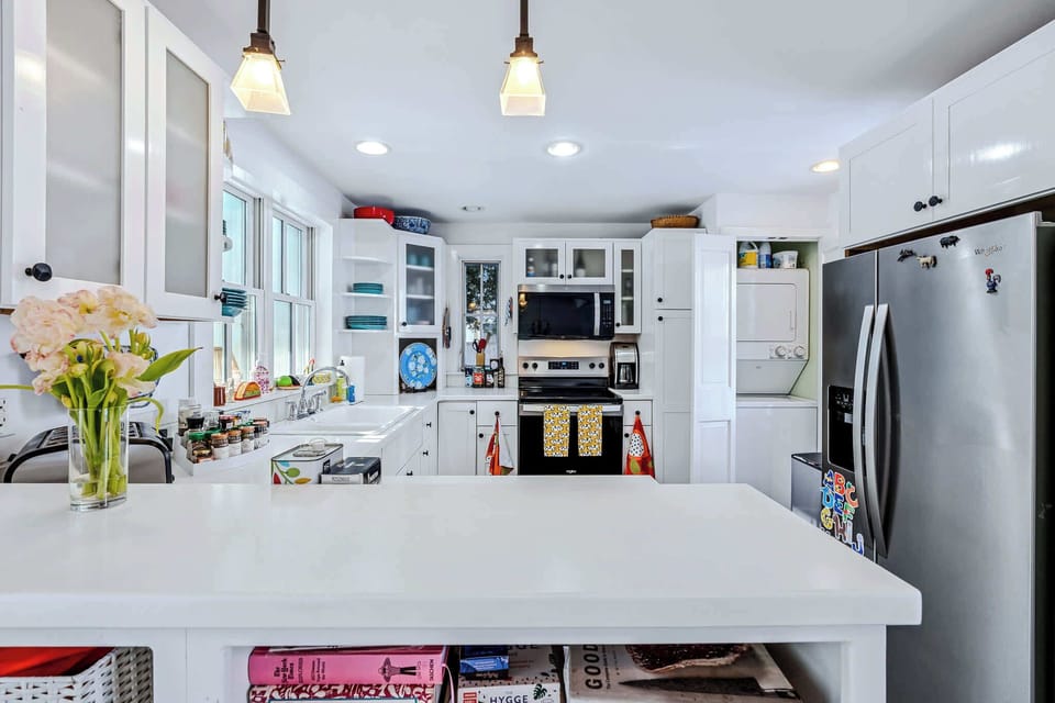 Fully equipped kitchen with stainless steel refrigerator and ample prep space