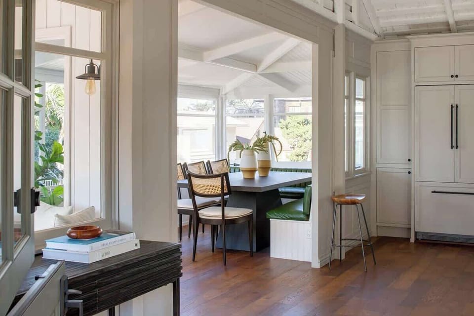 Enjoy meals in this cozy dining table, stylish cane chairs, and large windows that fill the space with natural light.