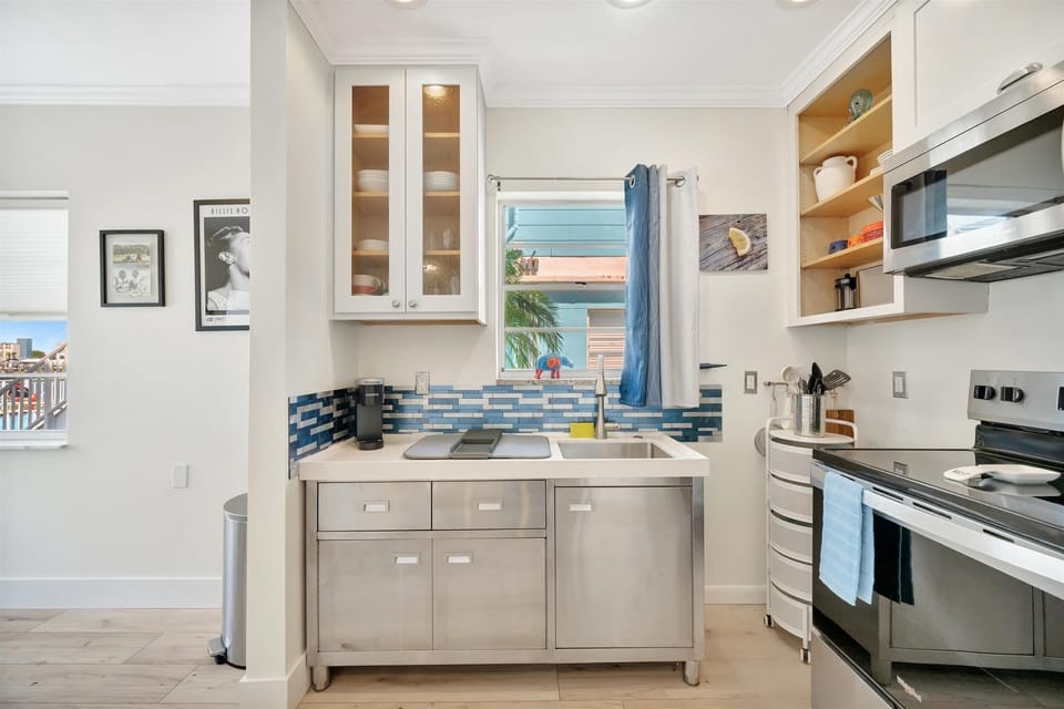 Renovated kitchen with stainless steel appliances and storage