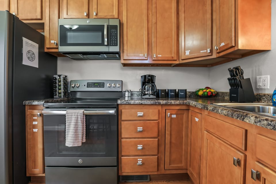 Fully stocked kitchen with all necessary pots, pans, bowls, silverware, cooking utensils, cups, plates, cutting boards, etc.