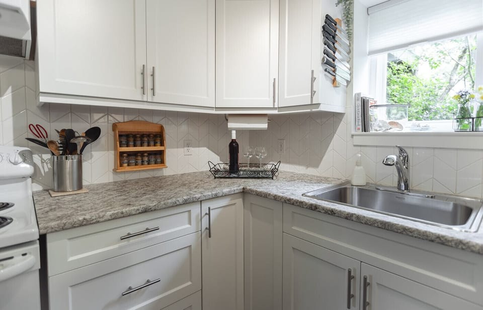 [Kitchen] Cooking made delightful: Experience the pleasure of preparing meals in our charming kitchen, offering essential appliances and a refreshing garden view.
