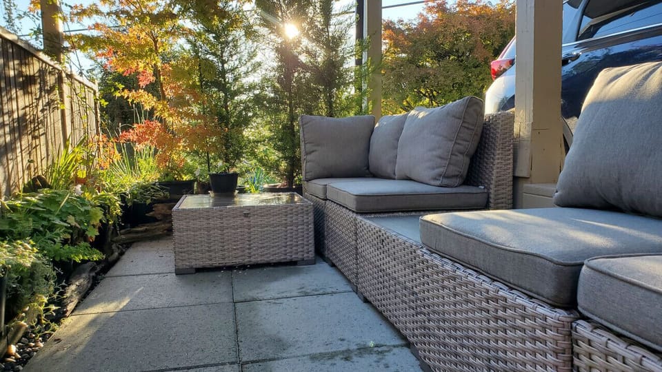 [Patio] A retreat in nature: Step into our idyllic patio oasis, where blooming flowers and comfortable seating create a haven for relaxation and outdoor dining.