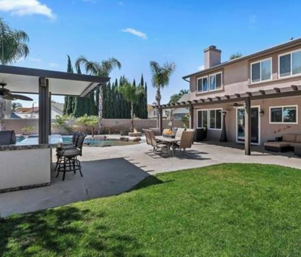 Back yard with bbq and lounging area .