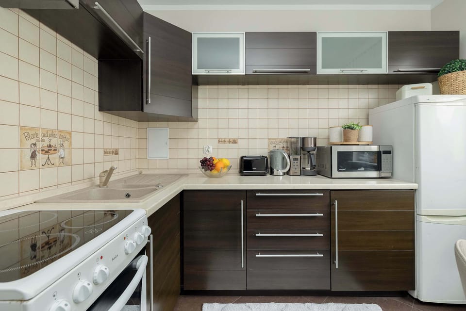 The kitchen layout is presented with a focus on the oven and the balance between dark lower cabinets and bright walls.