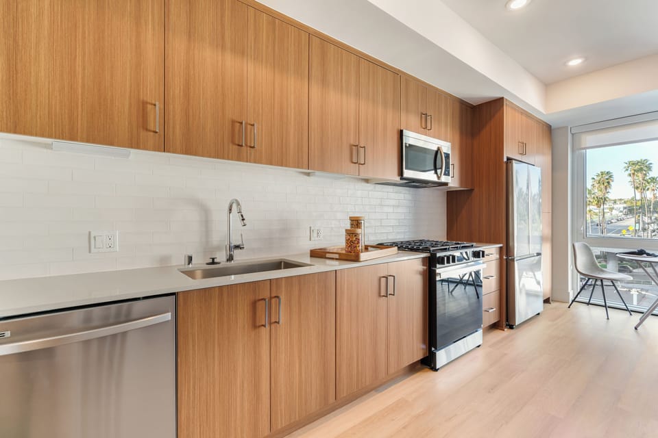 Cook in style with sleek quartz countertops, modern cabinetry, and stainless steel appliances.