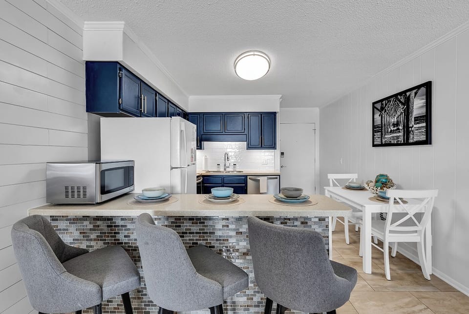 Enjoy Meals or Snacks from the Dining Table or the Breakfast Bar