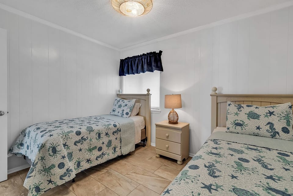 Your Guest Bedroom Features Two Single Beds With That Beachy Feel