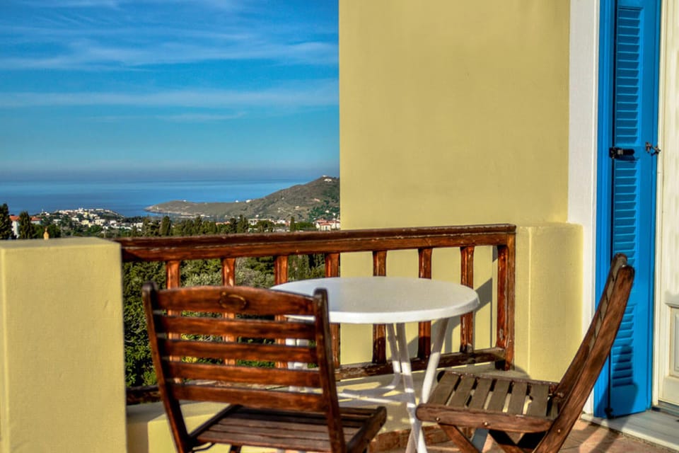 Private terrace with outdoor seating and open views toward the sea and coastline. A perfect place to enjoy morning coffee or sunset drinks while staying in the calm atmosphere of Menites village.