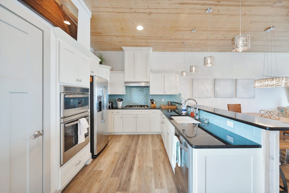 Your gourmet kitchen awaits with gleaming countertops, stainless steel appliances, and warm wood accents for memorable meal preparations.