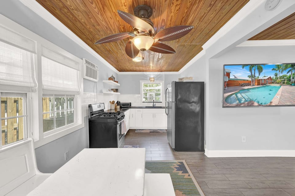 Bright secondary kitchen space with breakfast nook and modern appliances.