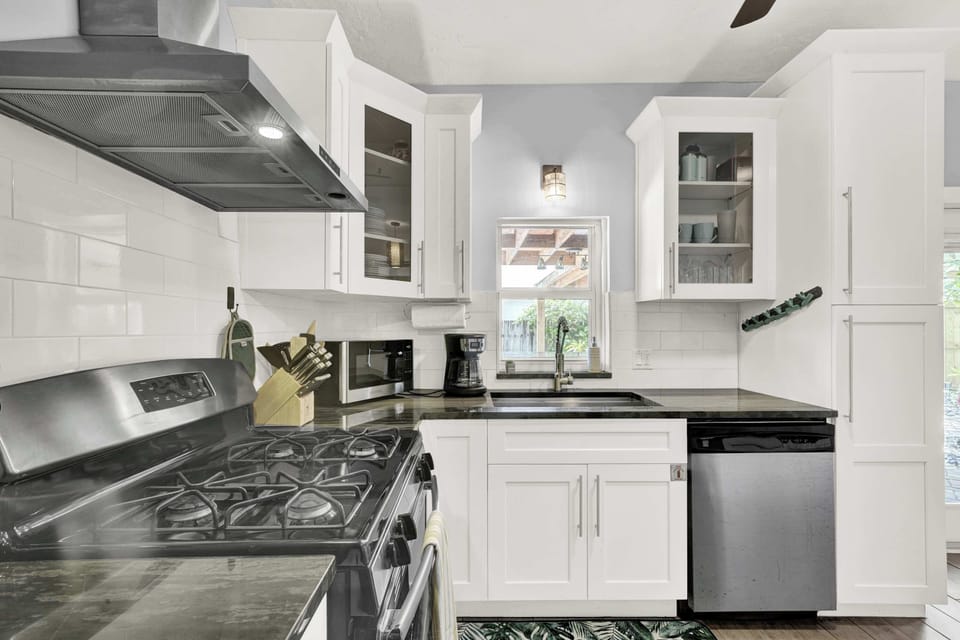 Fully equipped kitchen with gas stove and ample prep space.