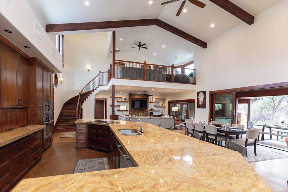 Your chef's paradise awaits with marble countertops, premium appliances, and soaring ceilings that create an elegant culinary sanctuary.