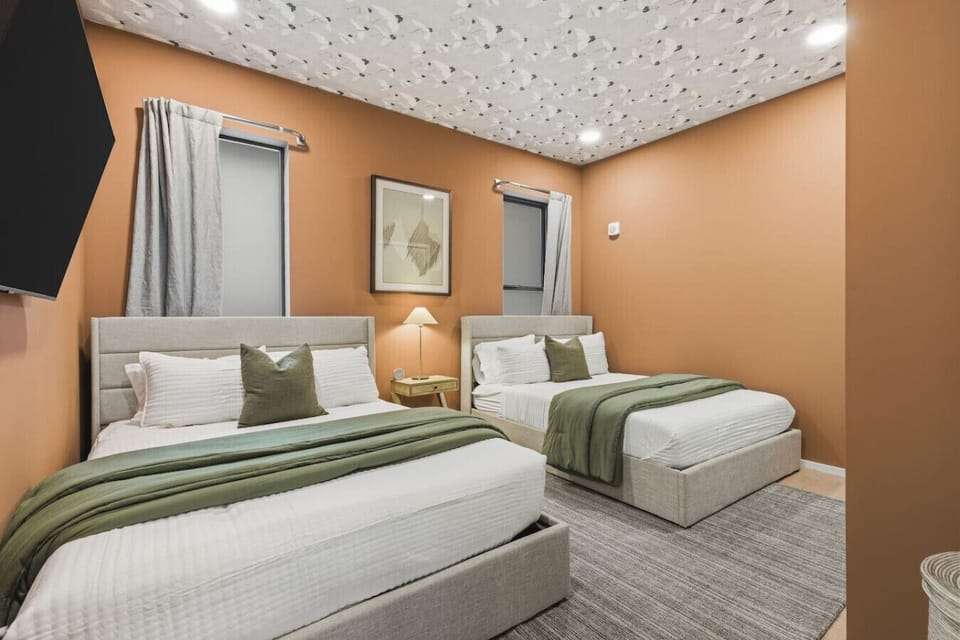 Bedroom with two comfortable Queen beds on the first floor of the condo. This bedroom has a HD TV with all the apps you could want, plus a closet to store your items in.