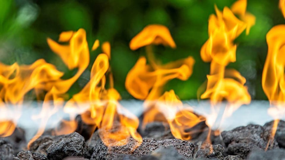Feel the warmth of the flames dancing, adding a cozy touch to your evening outdoors.