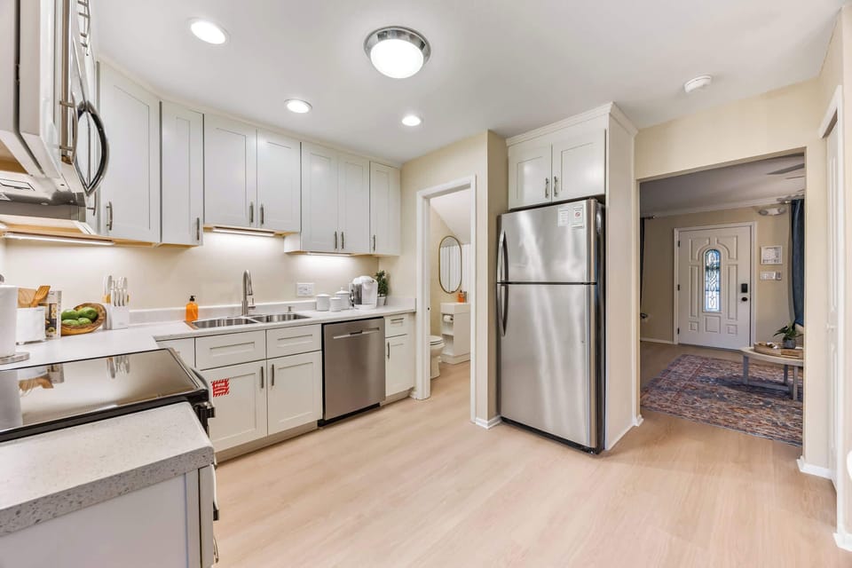 Modern kitchen with stainless steel appliances and white cabinetry