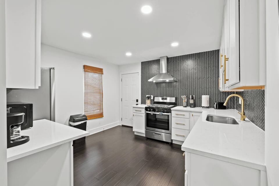 Bright, modern kitchen with sleek gas stove, oven, fridge, and dishwasher. Includes handy coffee pot, toaster, and electric kettle. Equipped with essentials, fire extinguisher & first aid kit. 