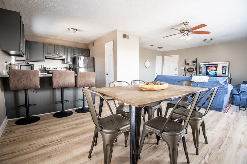 Unit E's dining space has plenty of seating with 6 chairs total and 3 bar seats. Great for a group card game or family meal together!