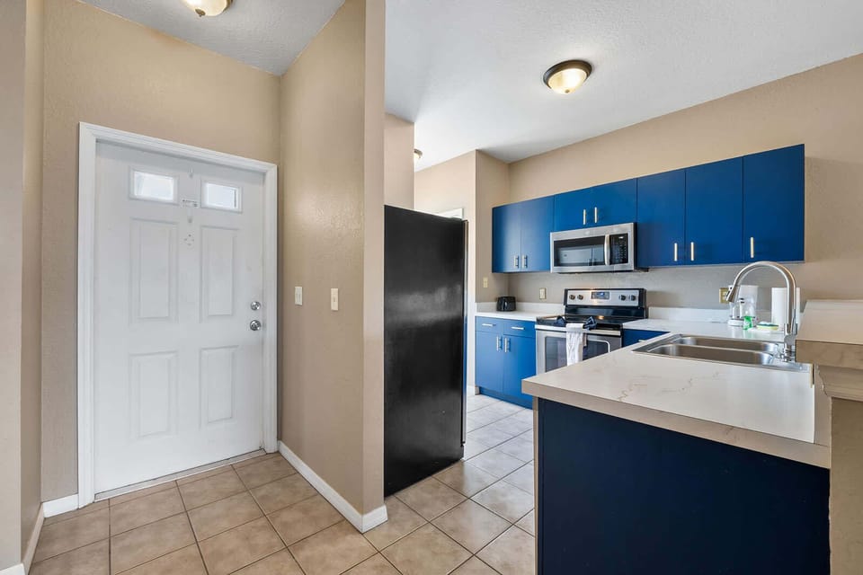 Modern kitchen with blue cabinetry and stainless steel appliances